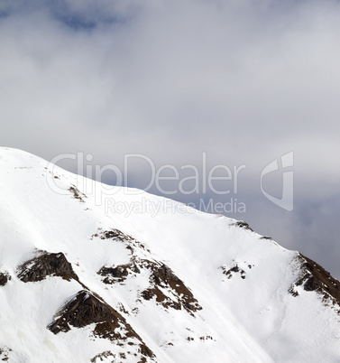 Winter mountains and sky with clouds at sun day