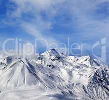 Winter snowy mountains in windy day