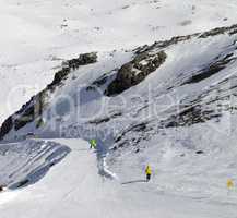 Snowboarders and skiers on groomed slope