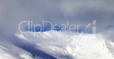 Panoramic view on off-piste slope in mist