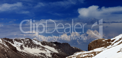 Panoramic view on rocks with snow.