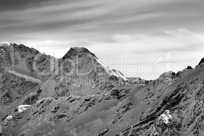 Black and white high mountains in winter evening