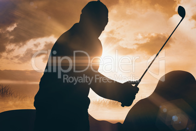 Composite image of golf player taking a shot