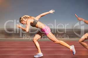 Composite image of sporty woman running on a white background