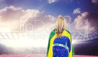 Athlete with brazilian flag wrapped around her body
