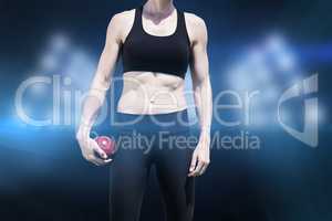 Composite image of sporty woman holding a red ball