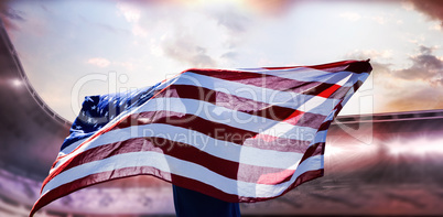 Composite image of rear view of sportsman posing with an america