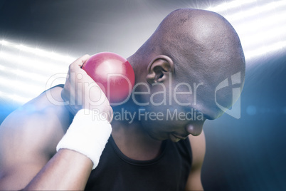 Composite image of portrait of sportsman practising shot put