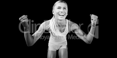 Portrait of sportswoman smiling and raising arms