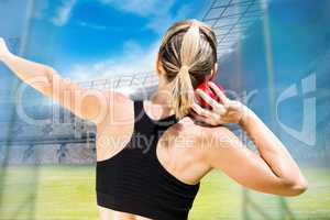 Composite image of rear view of sportswoman is practising shot p