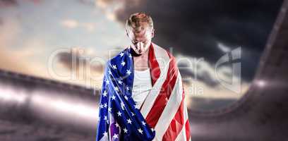 Composite image of athlete with american flag wrapped around his