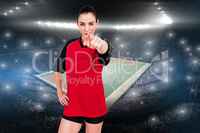 Composite image of female athlete pointing the camera