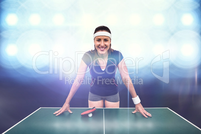 Composite image of happy female athlete leaning on hard table