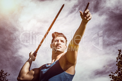 Composite image of low angle view of sportsman practising javeli