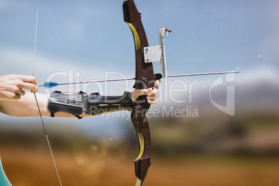 Composite image of close up of someone practising archery