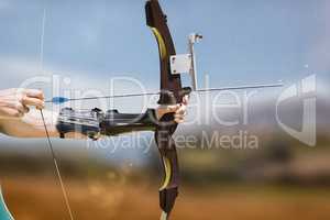 Composite image of close up of someone practising archery