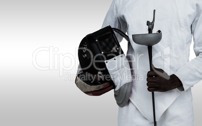 Composite image of mid-section of man standing with fencing mask