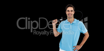 Badminton player standing on black background