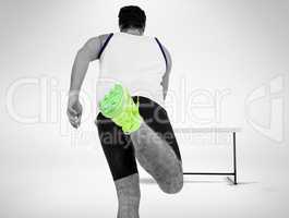 Rear view of male athlete running on white background