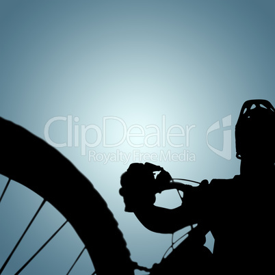 Composite image of man cycling with mountain bike