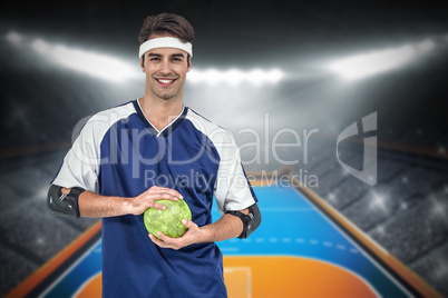 Composite image of sportsman posing with ball on white backgroun