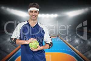 Composite image of sportsman posing with ball on white backgroun