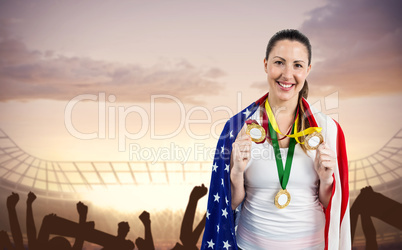 Athlete posing with gold medals after victory