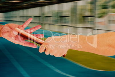 Composite image of athlete passing a baton to the partner