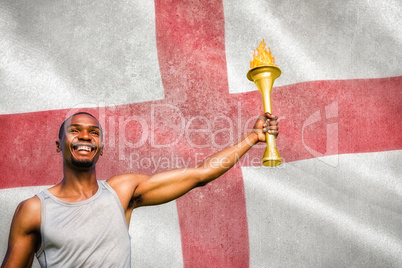 Composite image of front view of happy sportsman holding a cup