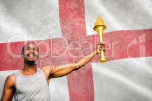 Composite image of front view of happy sportsman holding a cup