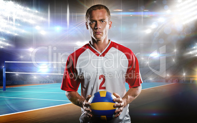 Composite image of sportsman holding a volleyball