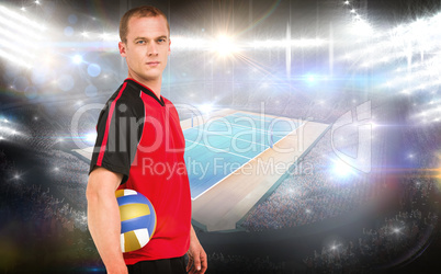 Composite image of sportsman holding a volleyball