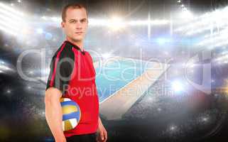 Composite image of sportsman holding a volleyball