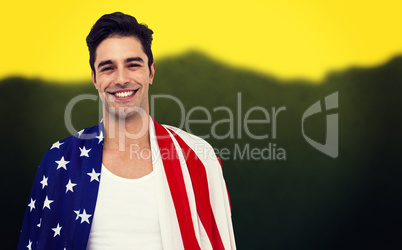 Athlete with american flag wrapped around his body against blurr