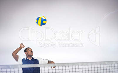 Composite image of sportsman posing while playing volleyball