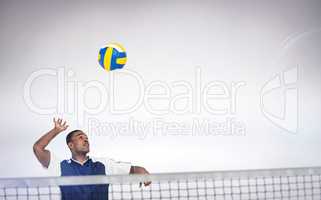 Composite image of sportsman posing while playing volleyball