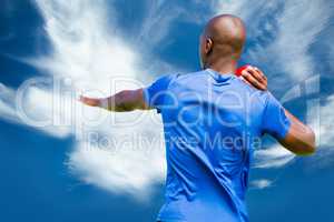 Composite image of rear view of sportsman is practising shot put
