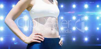 Composite image of sportswoman chest is posing with hands on hip