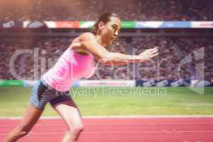 Composite image of an athletic woman starting to run