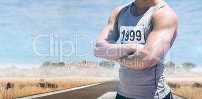 Composite image of handsome sportsman is posing with crossed arm