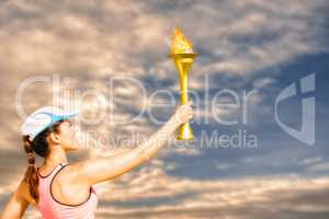 Composite image of rear view of happy sportswoman holding a cup