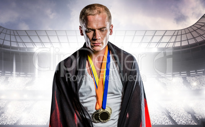 Composite image of athlete with german flag wrapped around his b