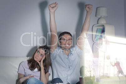 Composite image of man is watching sport on television next to h