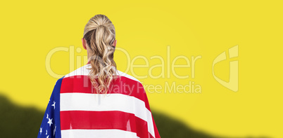 Composite image of athlete with american flag wrapped around his