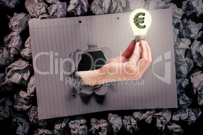 Composite image of hand holding environmental light bulb