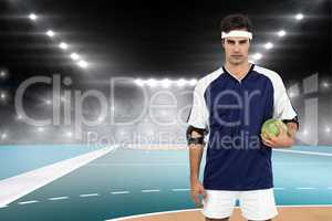 Composite image of sportsman standing with ball on white backgro