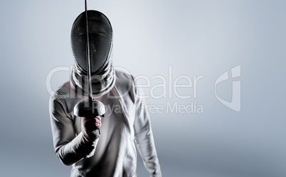 Composite image of man wearing fencing suit practicing with swor