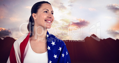 Athlete with american flag wrapped around his body against ameri