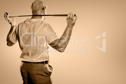 Rear view of golf player holding a golf club