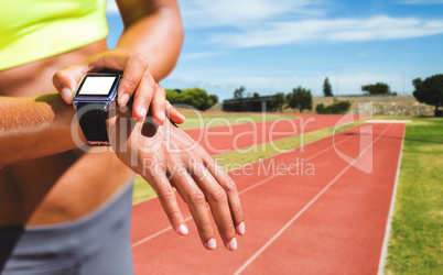 Composite image of close up on a sportswoman wearing a connected